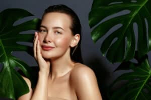 woman portrait with fresh green exotic tropical leaves