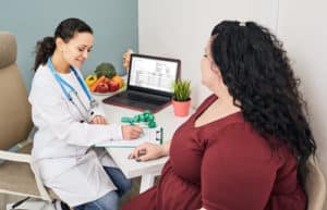 Nutritionist calculating body mass index of fat woman for obesity treatment